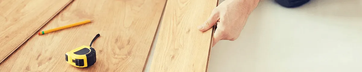 A professional installing wood flooring in Columbus, OH